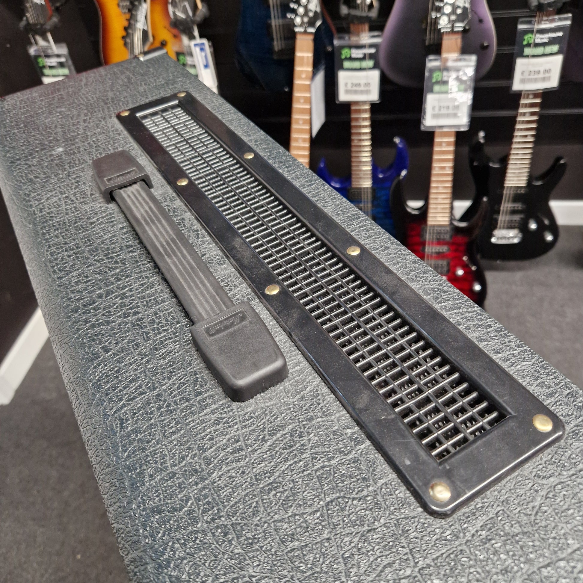 Pre-Owned Marshall JVM410H Guitar amplifier with a textured surface and visible branding, with guitars in the background.