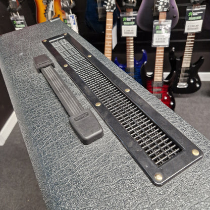 Pre-Owned Marshall JVM410H Guitar amplifier with a textured surface and visible branding, with guitars in the background.