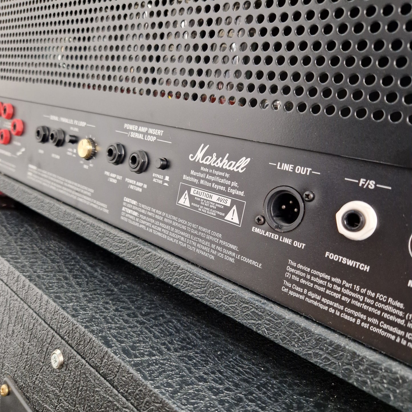 Pre-Owned Marshall JVM410H Close-up of a Marshall amplifier with control knobs and input/output ports.