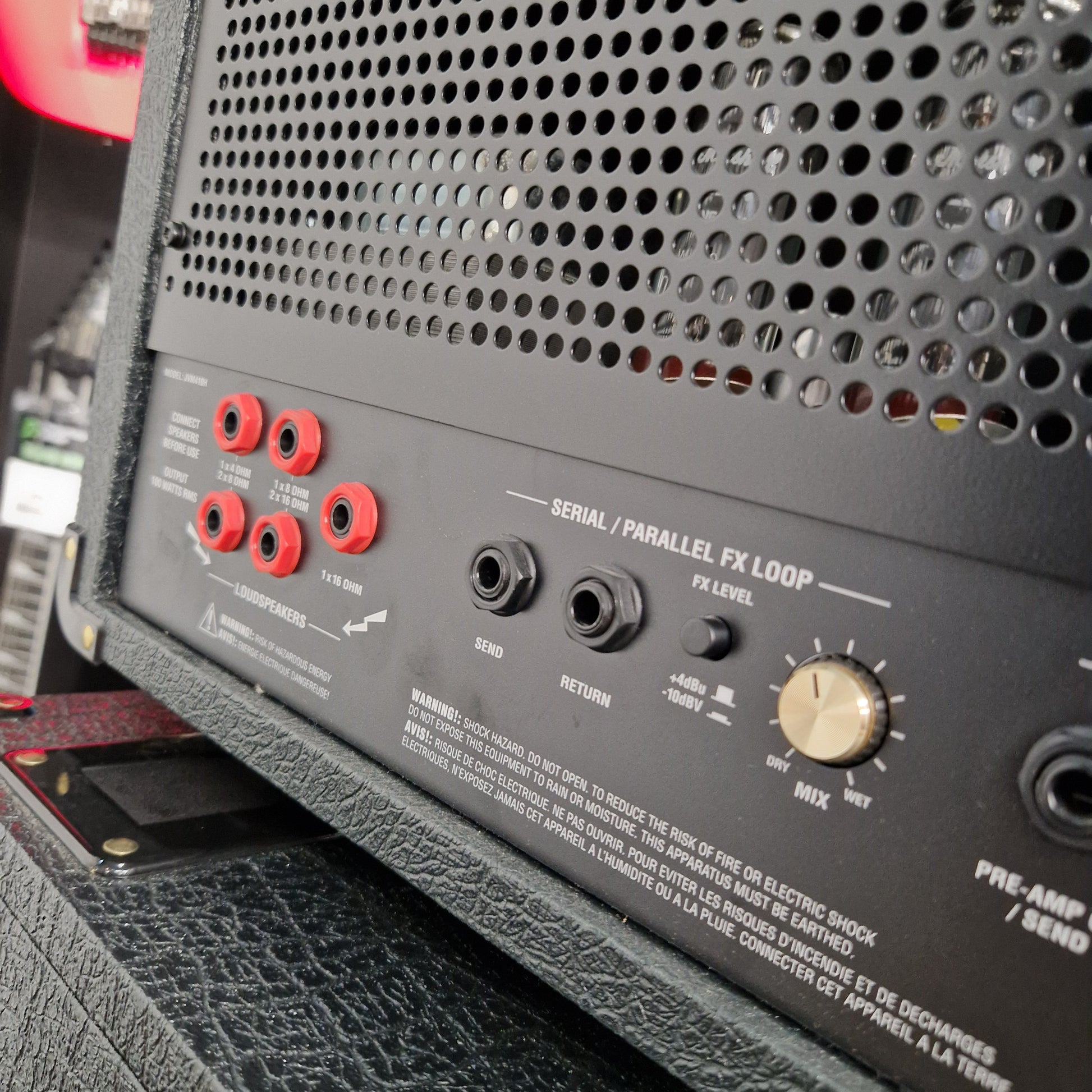 Pre-Owned Marshall JVM410H Close-up of an audio equipment panel with knobs and connectors.