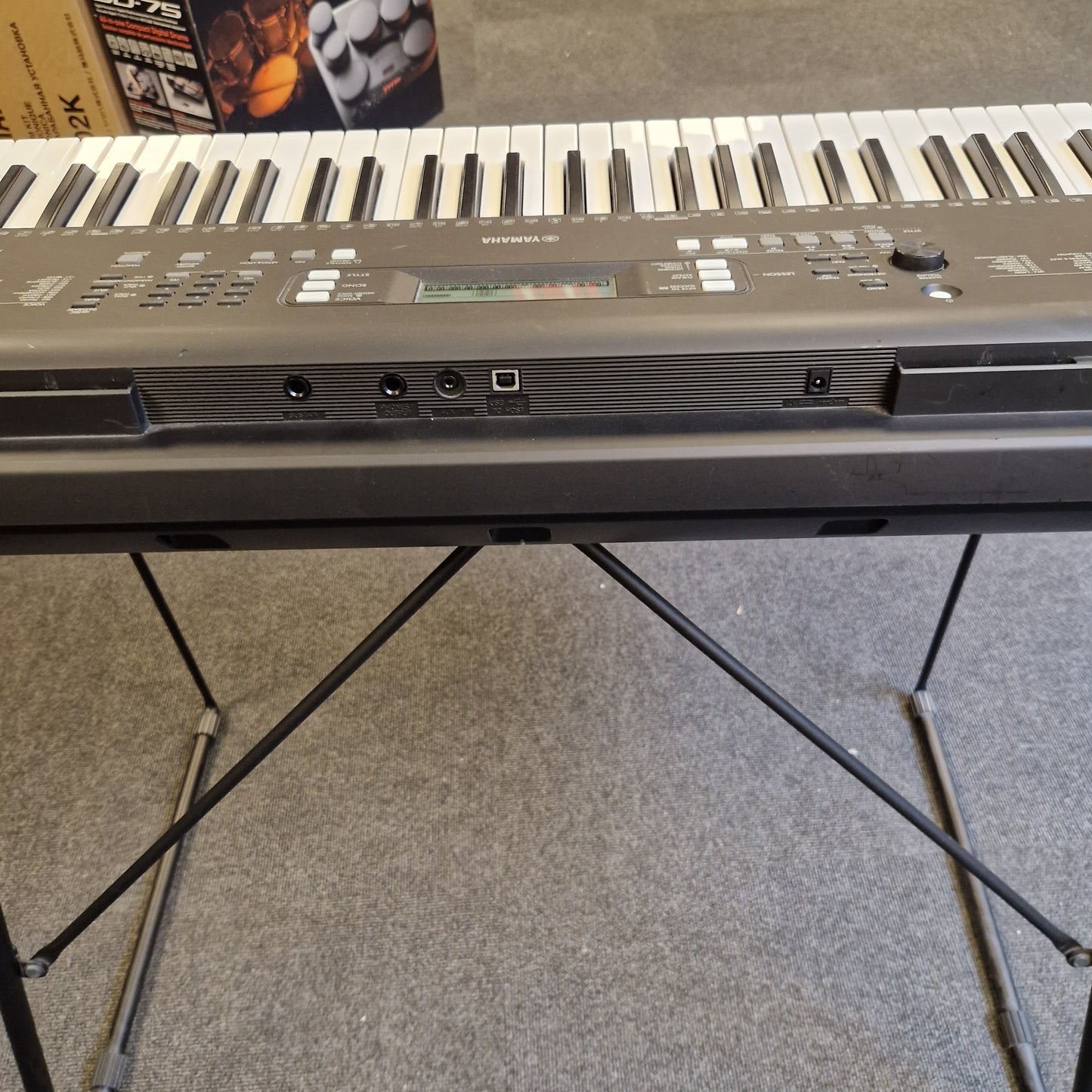 Pre-Owned Yamaha PSR-EW310 Close-up of a keyboard with a textured wall in the background