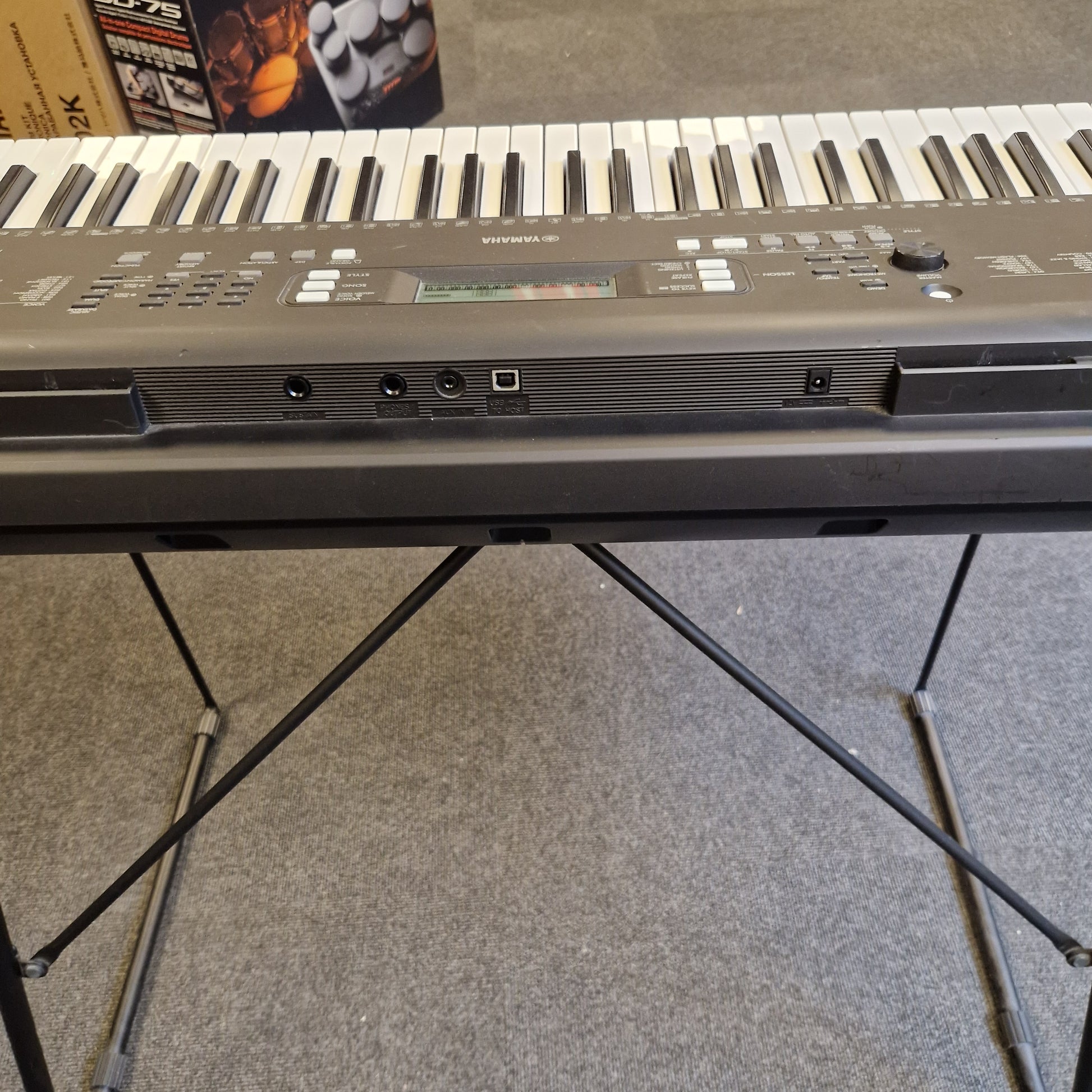 Pre-Owned Yamaha PSR-EW310 Close-up of a keyboard with a textured wall in the background