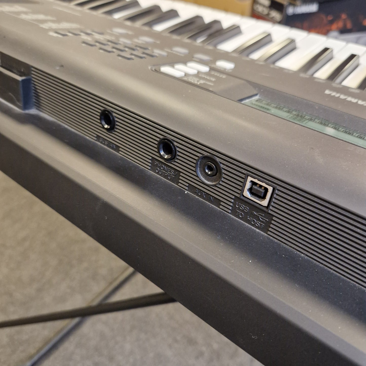 Pre-Owned Yamaha PSR-EW310 Close-up of a computer monitor with ports and connectors on a blurred background