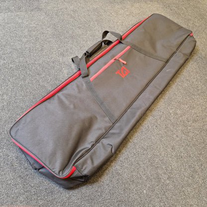 Pre-Owned Yamaha PSR-EW310 Gray and red guitar case on a textured surface