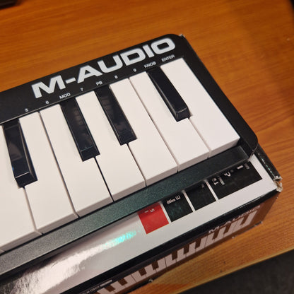 Pre-Owned M-Audio Keystation Mini 32 M-Audio keyboard controller on a wooden surface