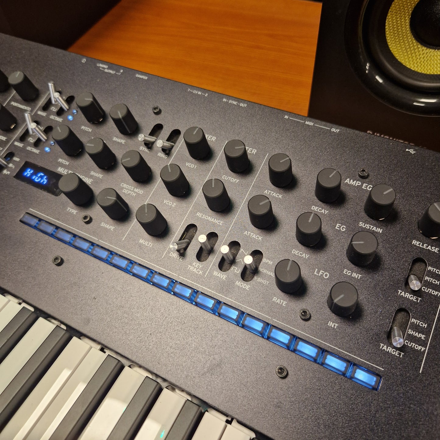 Pre-Owned Korg Minilogue XD Control panel of a synthesizer with knobs and buttons on a wooden surface