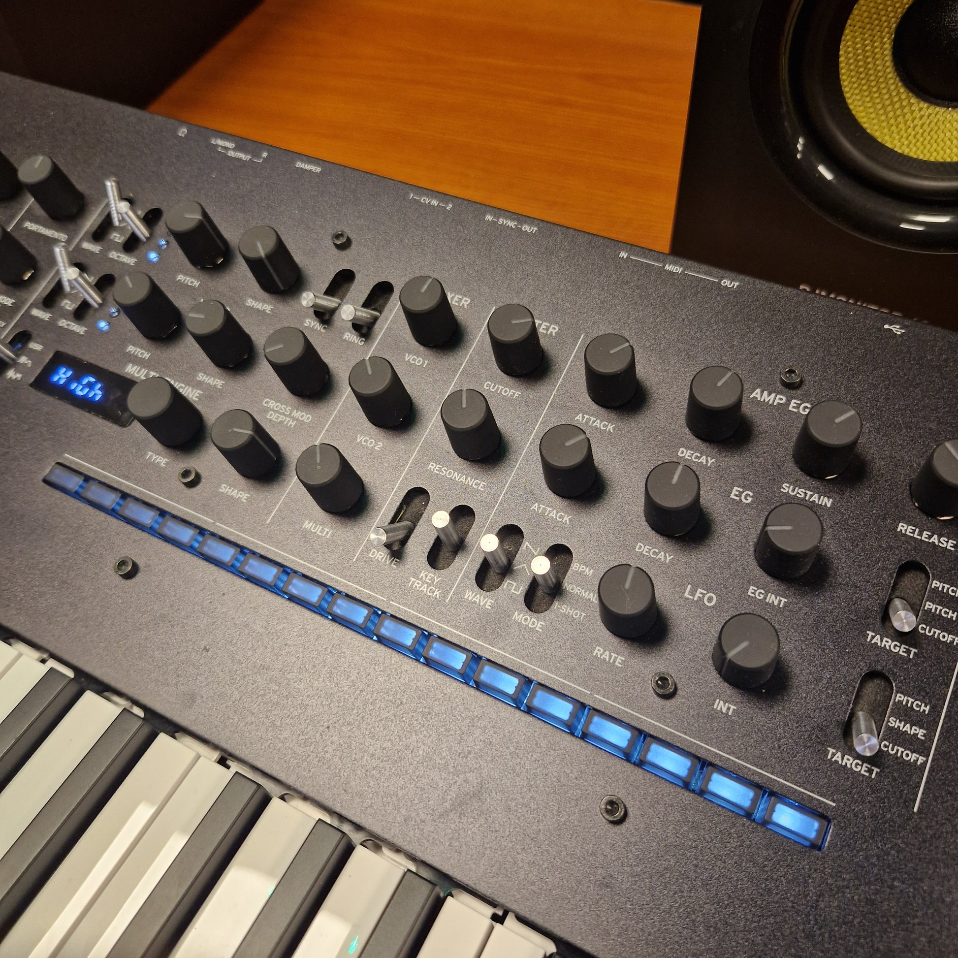 Pre-Owned Korg Minilogue XD Control panel of a synthesizer with knobs and buttons on a wooden surface