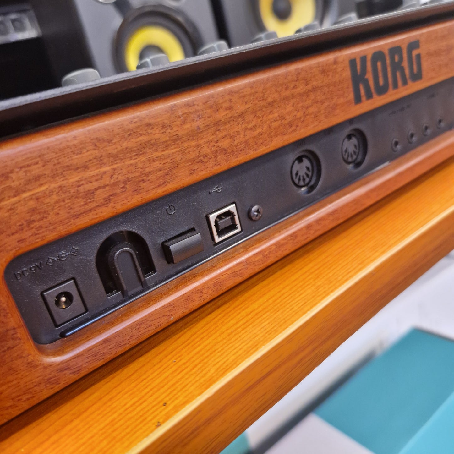 Pre-Owned Korg Minilogue XD Close-up of a KORG electronic device with wooden finish and control panel.