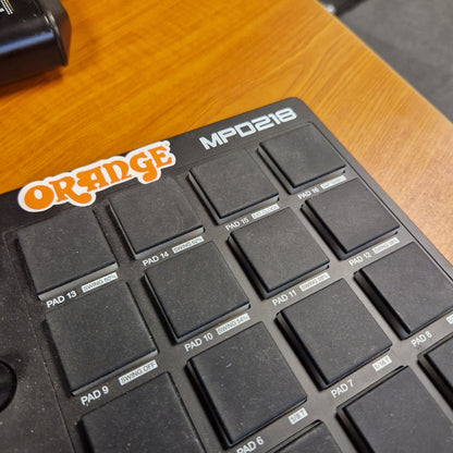Pre-Owned Akai MPD218 Black MIDI controller with 'Orange' branding on a wooden surface