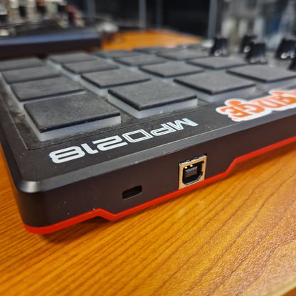 Pre-Owned Akai MPD218 Black and red electronic device with 'Ninja' branding on a wooden surface