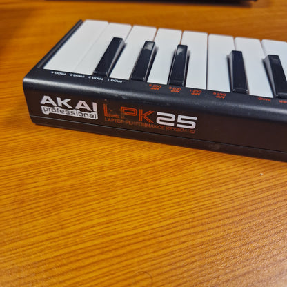 Pre-Owned Akai LPK25 Akai LPK25 MIDI keyboard on a wooden surface