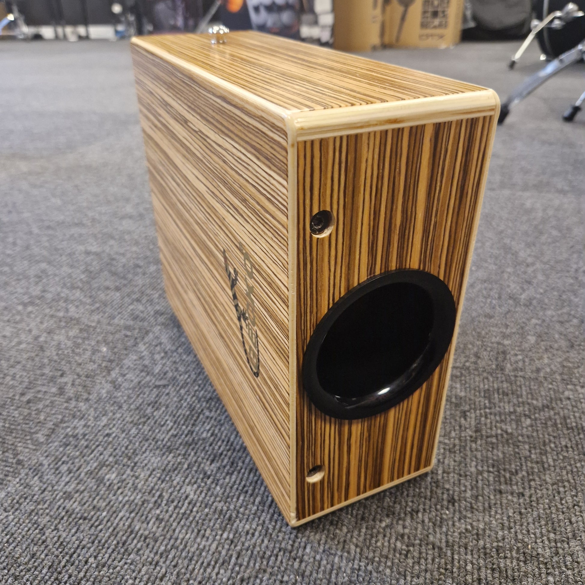 Pre-Owned Gecko C-68Z Wooden speaker box with a black driver on a textured surface
