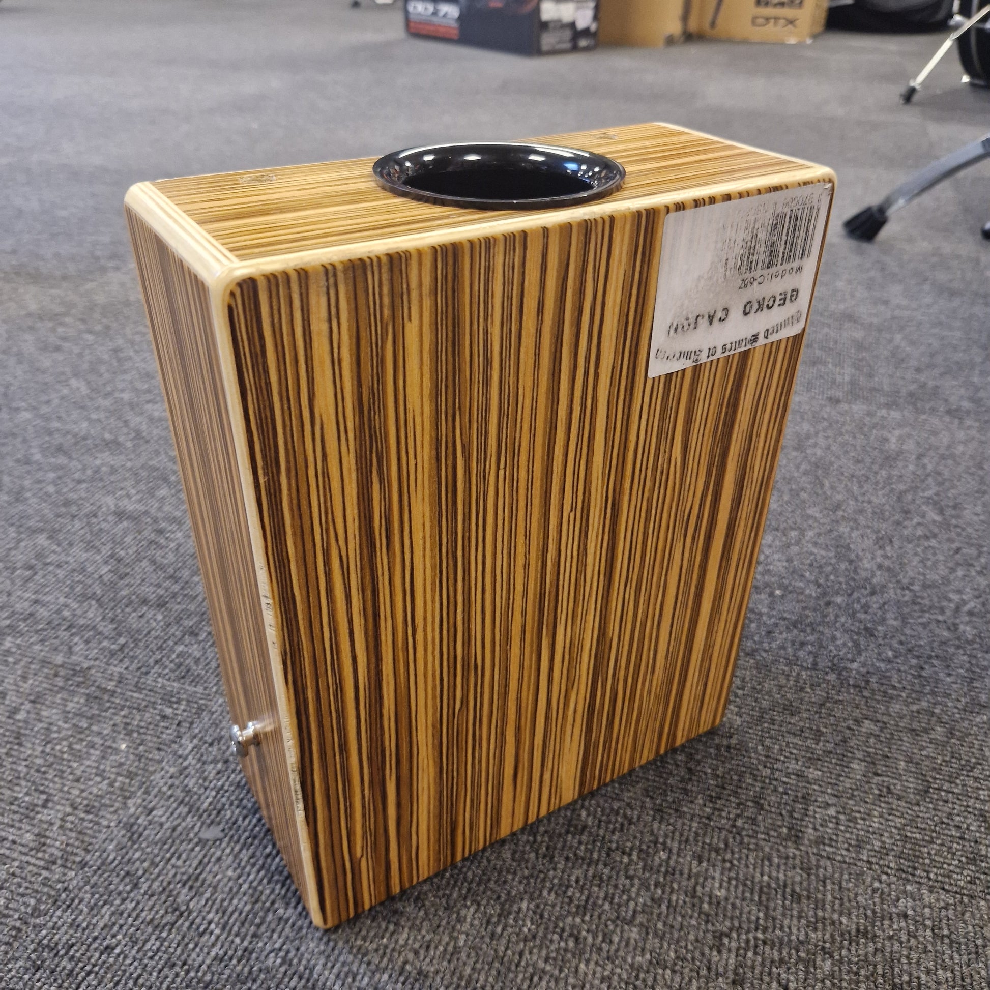 Pre-Owned Gecko C-68Z Wooden cajon drum on a gray carpet