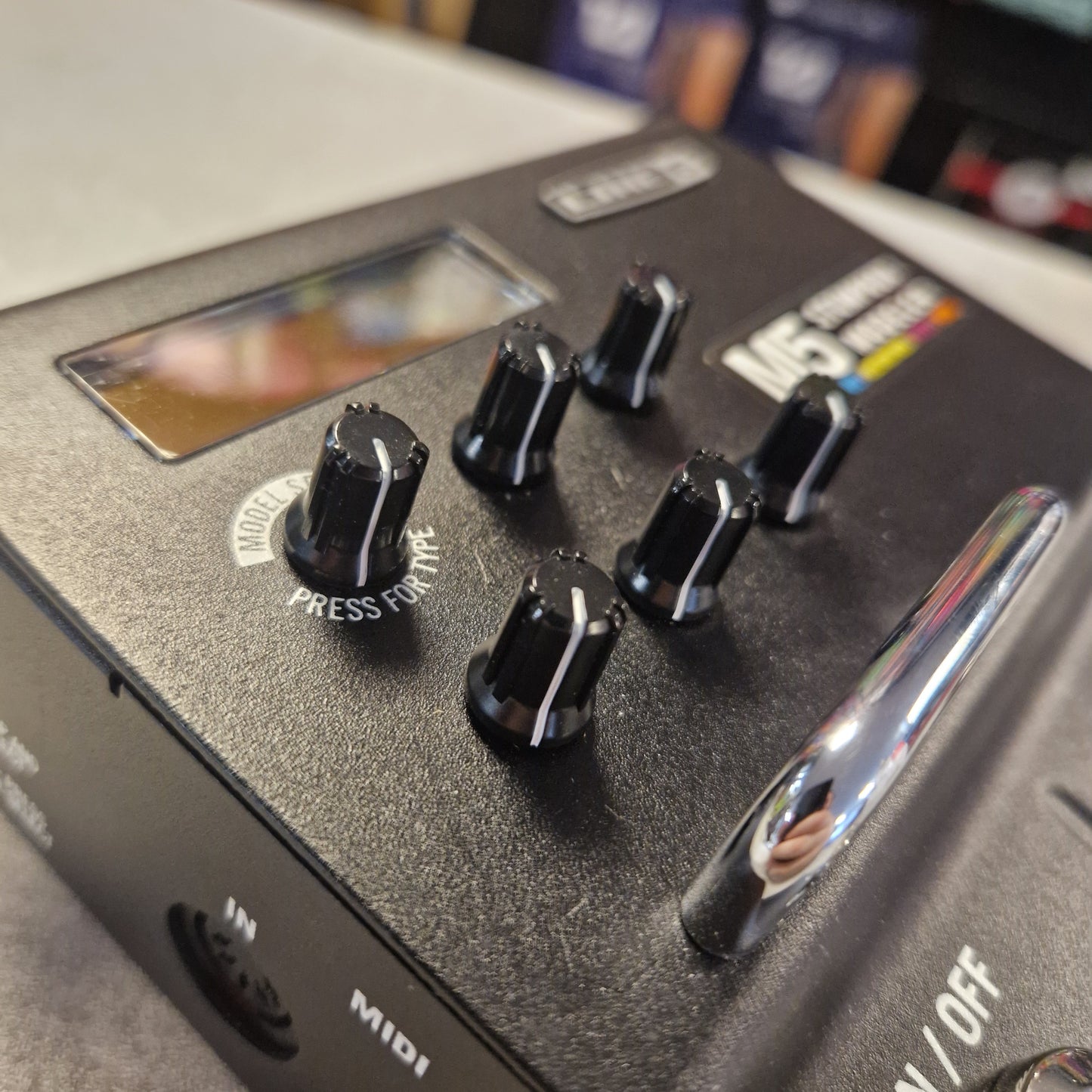 Pre-Owned Line 6 M5 Close-up of a control panel with switches and buttons on a device.