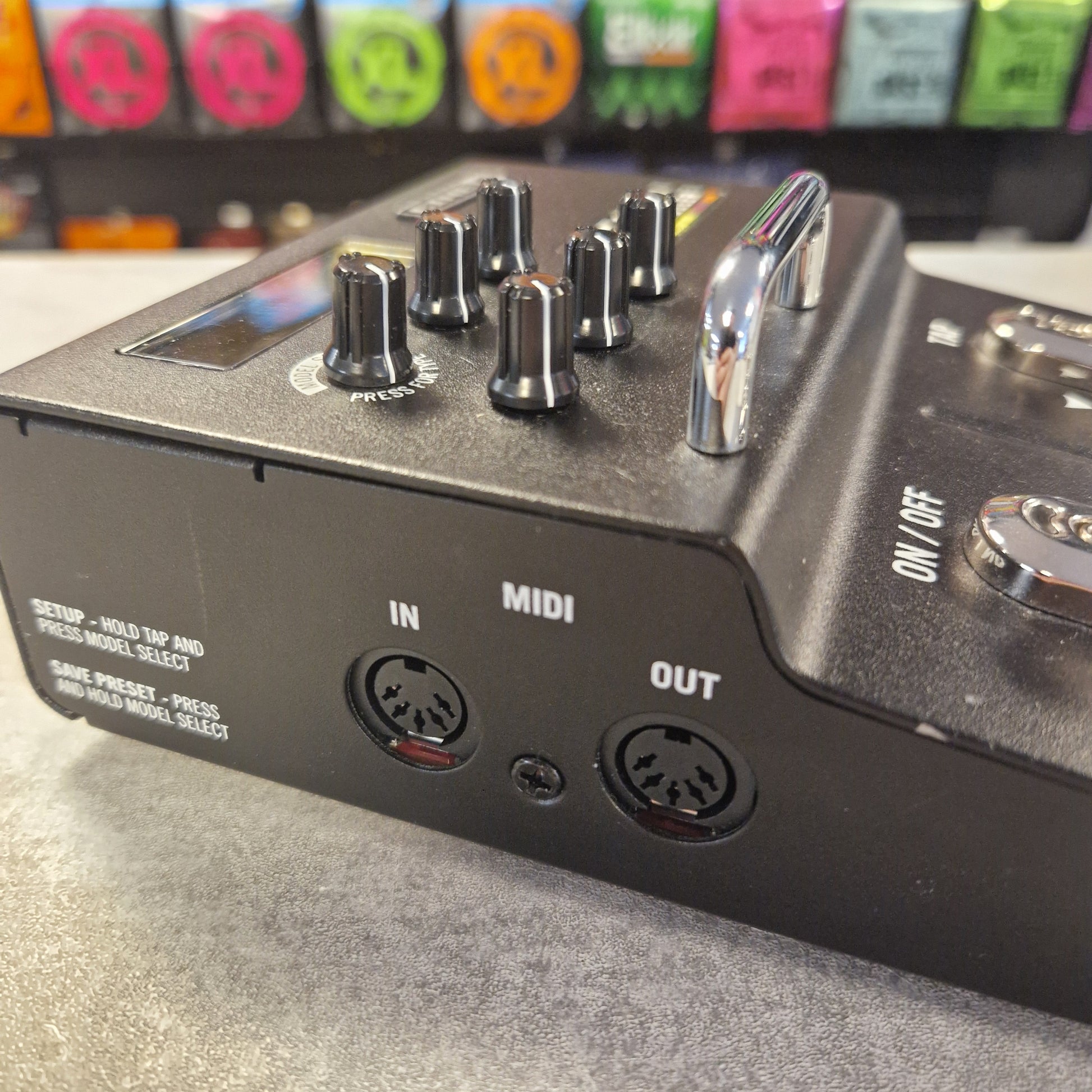 Pre-Owned Line 6 M5 Close-up of a musical instrument control panel with knobs and ports.