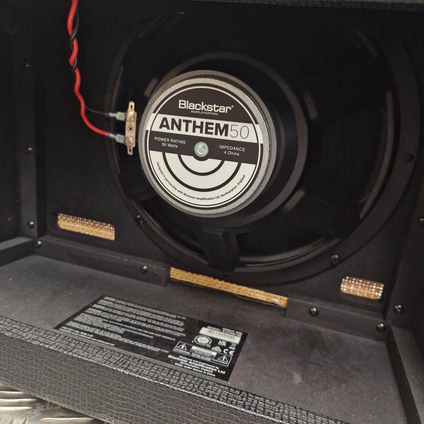 Pre-Owned Blackstar Debut 50R Close-up of a Blackstar Anthem 60 speaker in a guitar amplifier cabinet.
