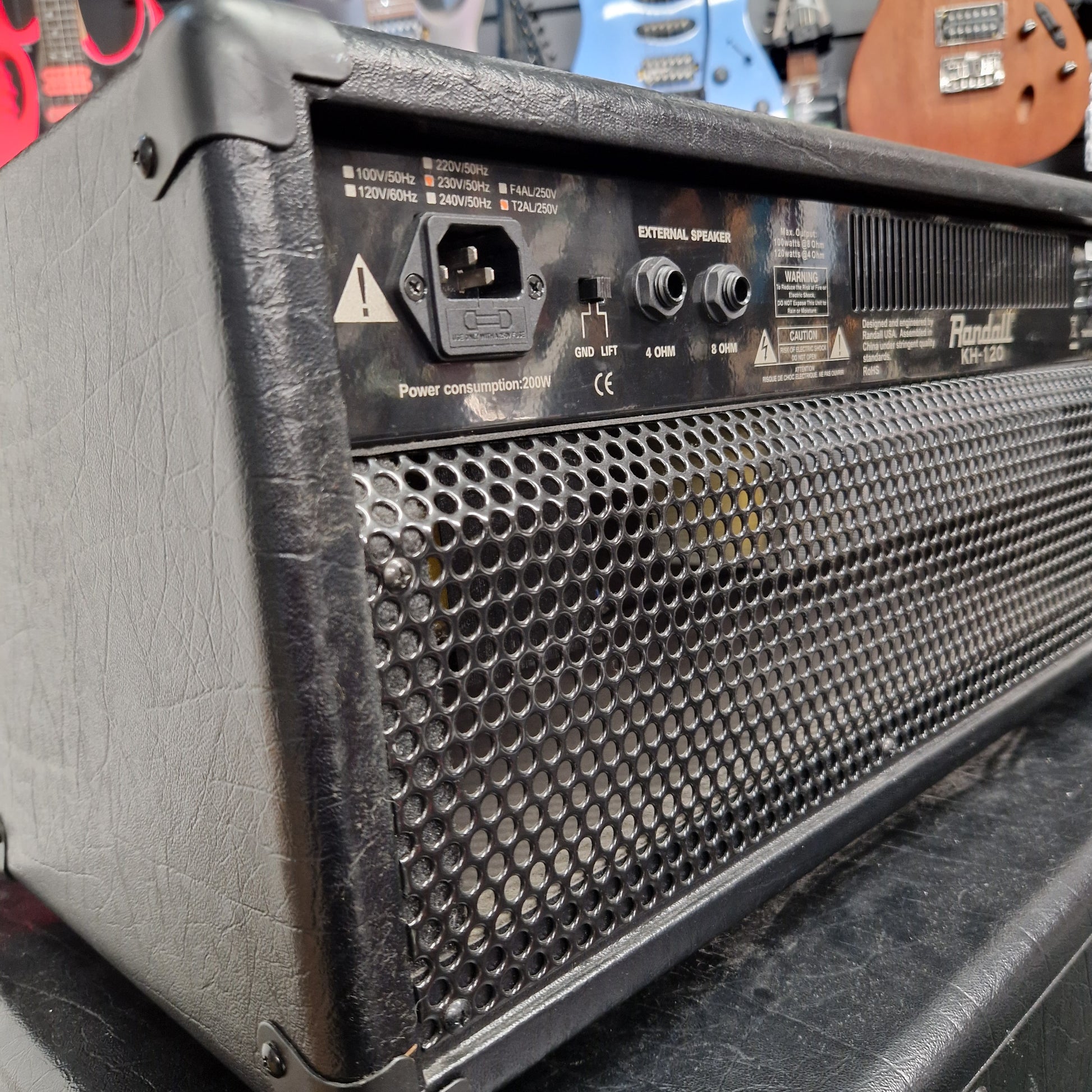 Pre-Owned Randall KH-120 Close-up of a guitar amplifier with control panel and mesh design.