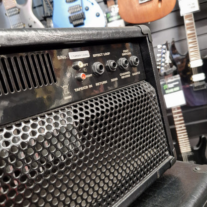Pre-Owned Randall KH-120 Guitar amplifier with control panel and speaker grille, surrounded by guitars in a studio setting.