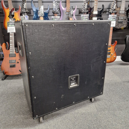 Pre-Owned Randall KH-120 Black speaker cabinet on a gray floor with guitars in the background