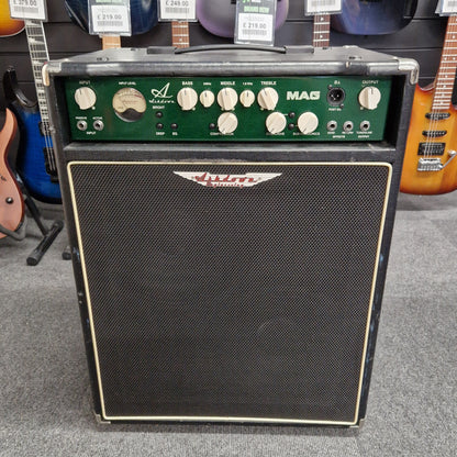 Pre-Owned Ashdown MAG-C210T-300EVO Guitar amplifier and speaker on a gray floor with guitars in the background 