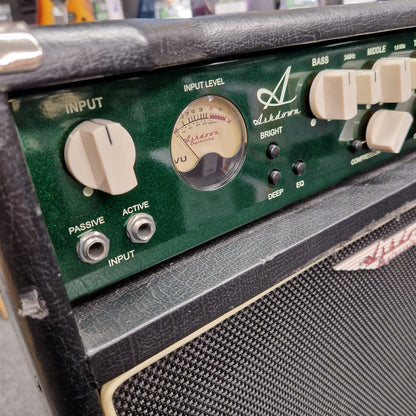 Pre-Owned Ashdown MAG-C210T-300EVO Close-up of a guitar amplifier control panel with various knobs and labels.