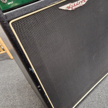 Pre-Owned Ashdown MAG-C210T-300EVO Close-up of a black speaker grill with a brand logo on a gray surface