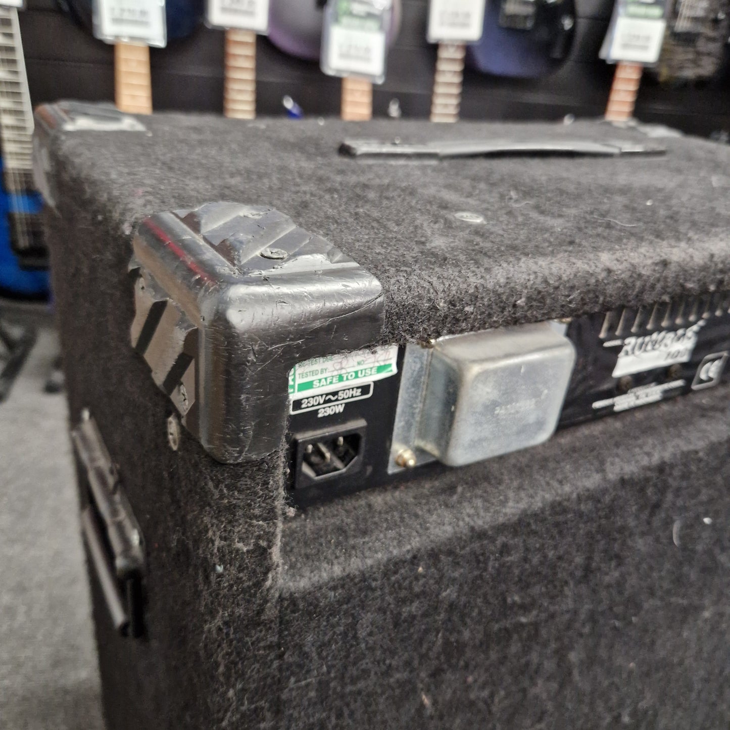 Pre-Owned Fender Rumble 100 Close-up of a guitar amplifier with visible components