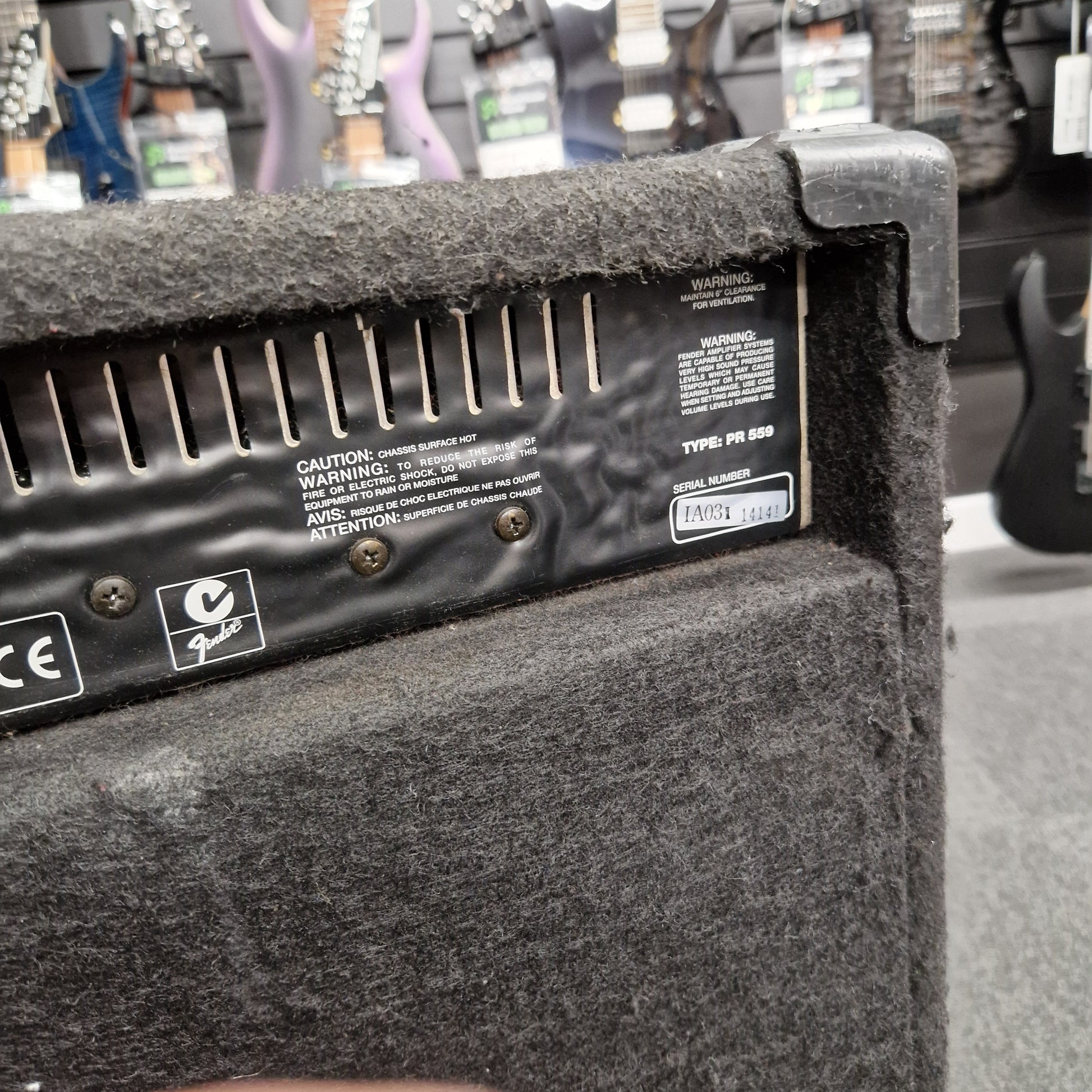 Pre-Owned Fender Rumble 100 Guitar amplifier with control panel and branding in a music store setting