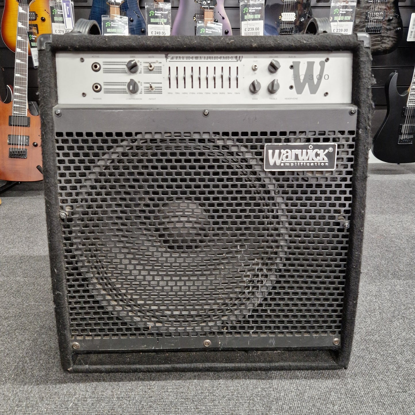 Pre-Owned Warwick BC300 Wampler pedal board with visible branding on a gray surface