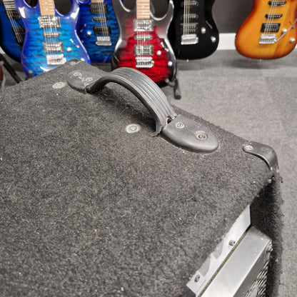 Pre-Owned Warwick BC300 Close-up of a guitar case with guitars in the background