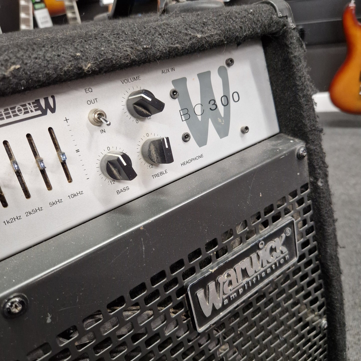 Pre-Owned Warwick BC300 Wampler pedal with control knobs and branding on a guitar amplifier.