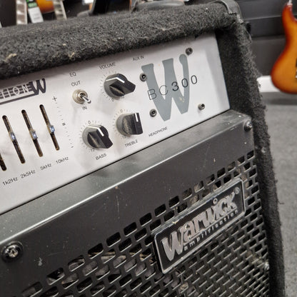 Pre-Owned Warwick BC300 Wampler pedal with control knobs and branding on a guitar amplifier.