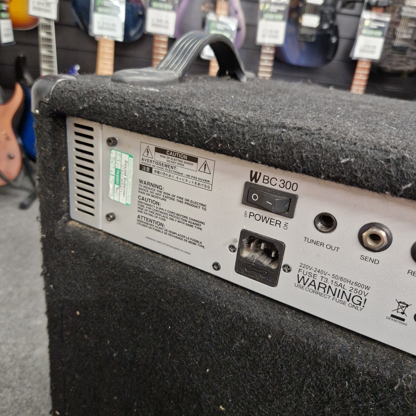 Pre-Owned Warwick BC300 Back panel of a speaker with various ports and labels in an indoor setting.