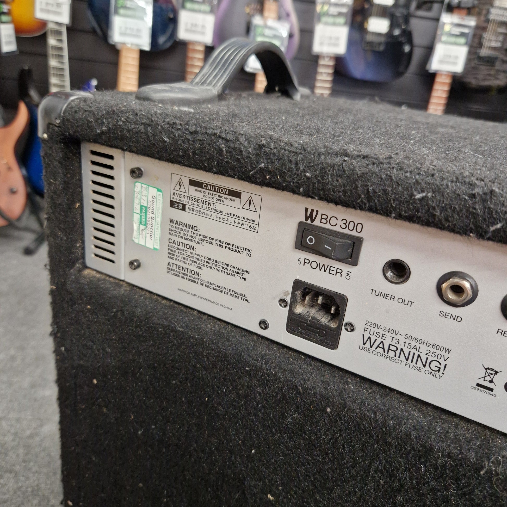 Pre-Owned Warwick BC300 Back panel of a speaker with various ports and labels in an indoor setting.