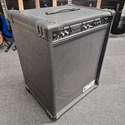 Pre-Owned Crate BX-100 Guitar amplifier on a gray carpet with guitars in the background