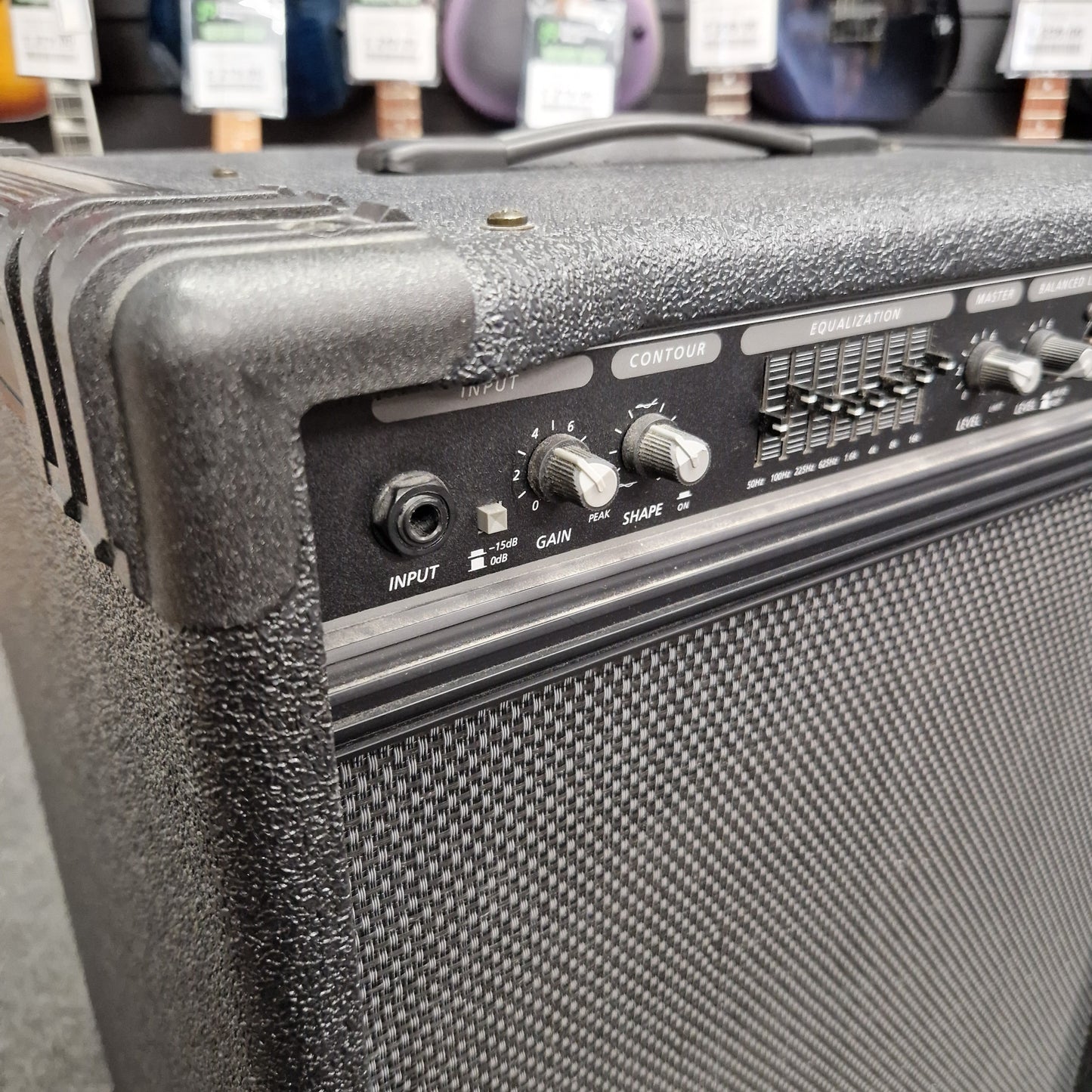 Pre-Owned Crate BX-100 Close-up of a guitar amplifier with control knobs and labels.
