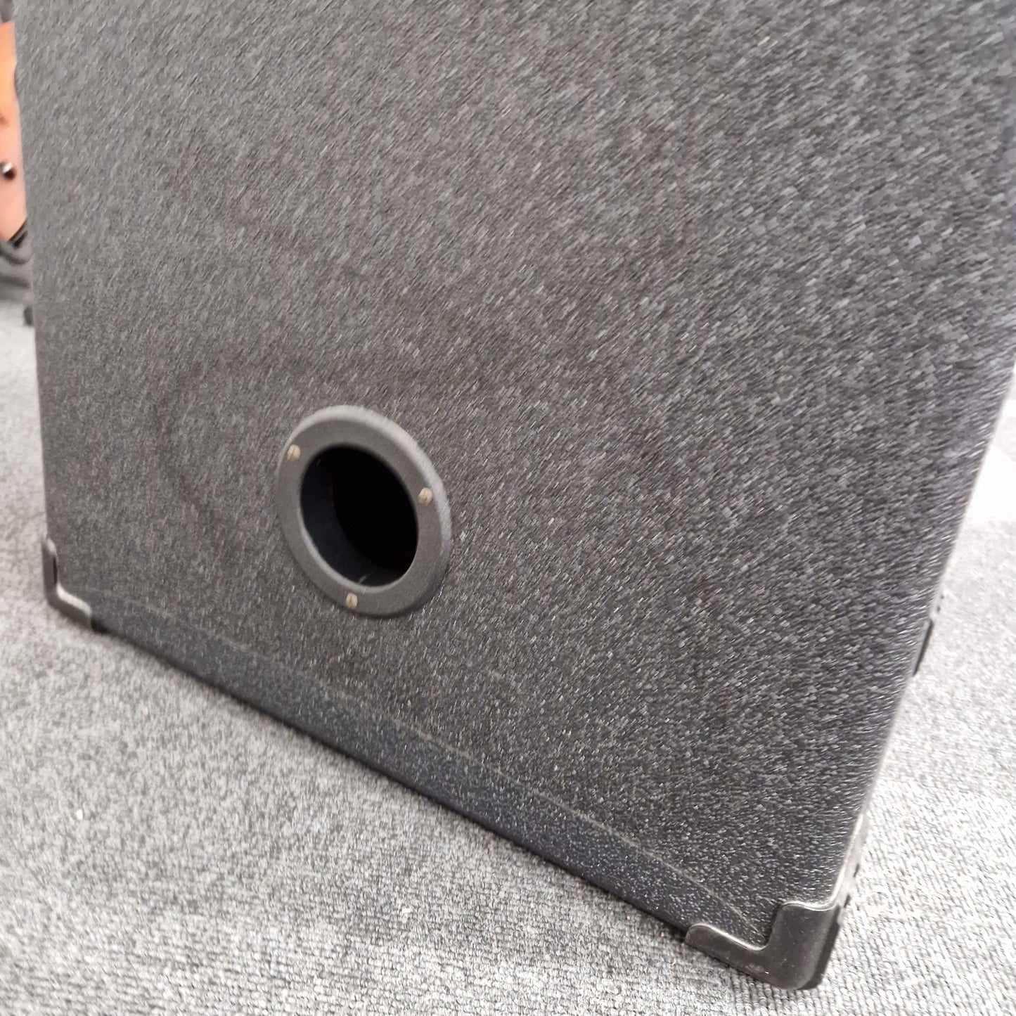 Pre-Owned Crate BX-100 Close-up of a gray textured surface with a circular hole.