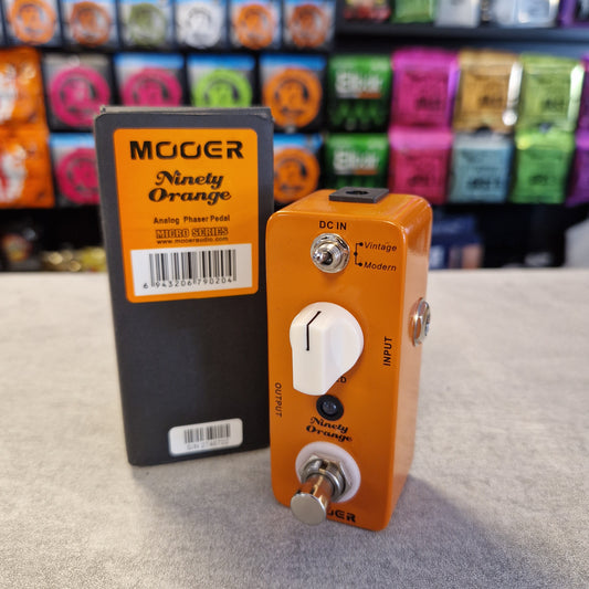Pre-Owned Mooer MPH1 Orange guitar effects pedal with a visible brand label on a textured surface.