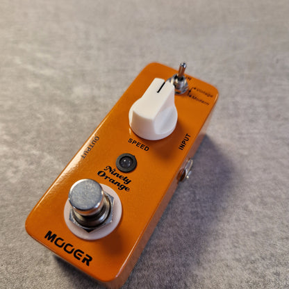 Pre-Owned Mooer MPH1 Orange guitar effects pedal with 'Moog' branding on a textured surface