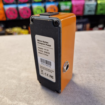 Pre-Owned Mooer MPH1 Orange and black electronic pedal with a label on a textured surface