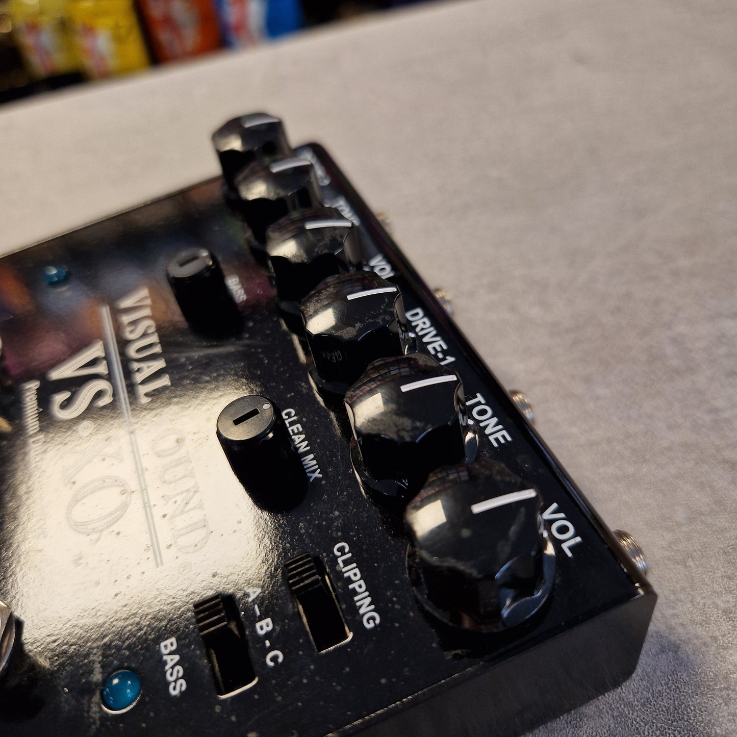 Pre-Owned Truetone VSXO Guitar effects pedal with control knobs and labels on a blurred background