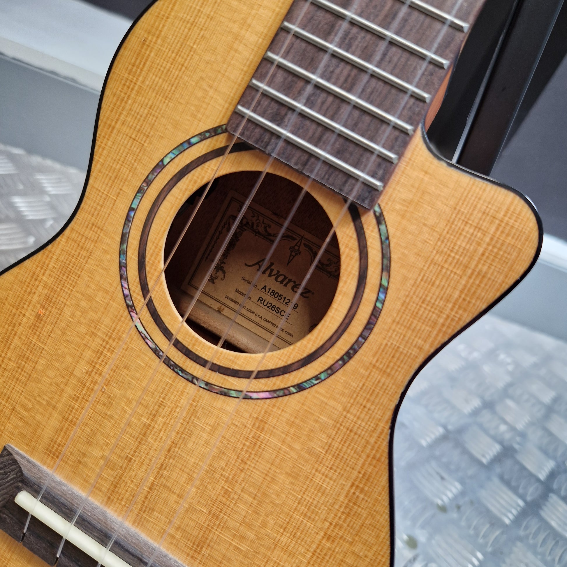 Pre-Owned Alvarez RU26CCE Close-up of a guitar with a blurred background