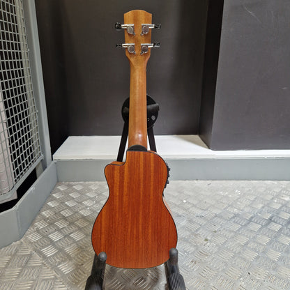 Pre-Owned Alvarez RU26CCE Wooden ukulele leaning against a metal wall.