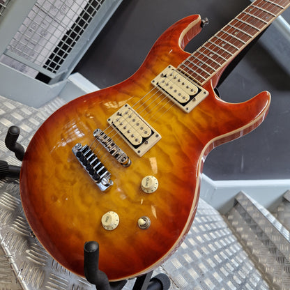 Pre-Owned Samick Electric guitar with a sunburst finish on a metal surface