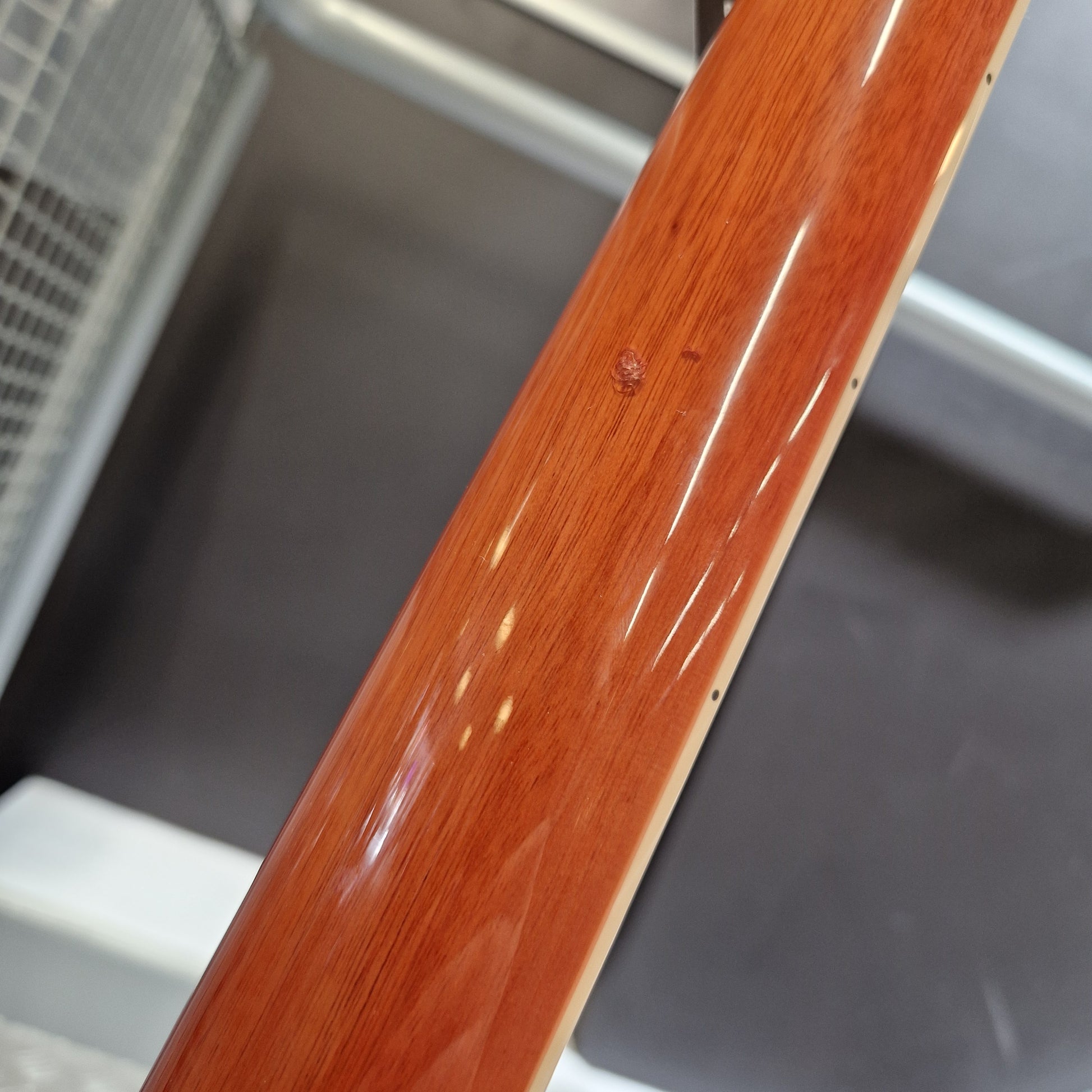 Pre-Owned Samick Close-up of a wooden chair armrest with a blurred background