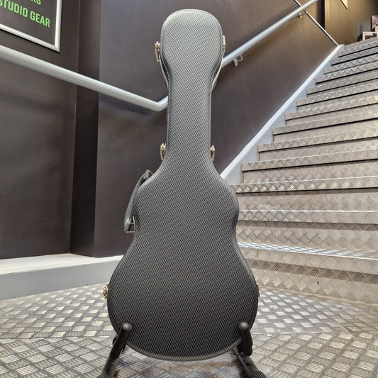 Pre-Owned TGI ABS Guitar case on display in a store with a patterned wall in the background