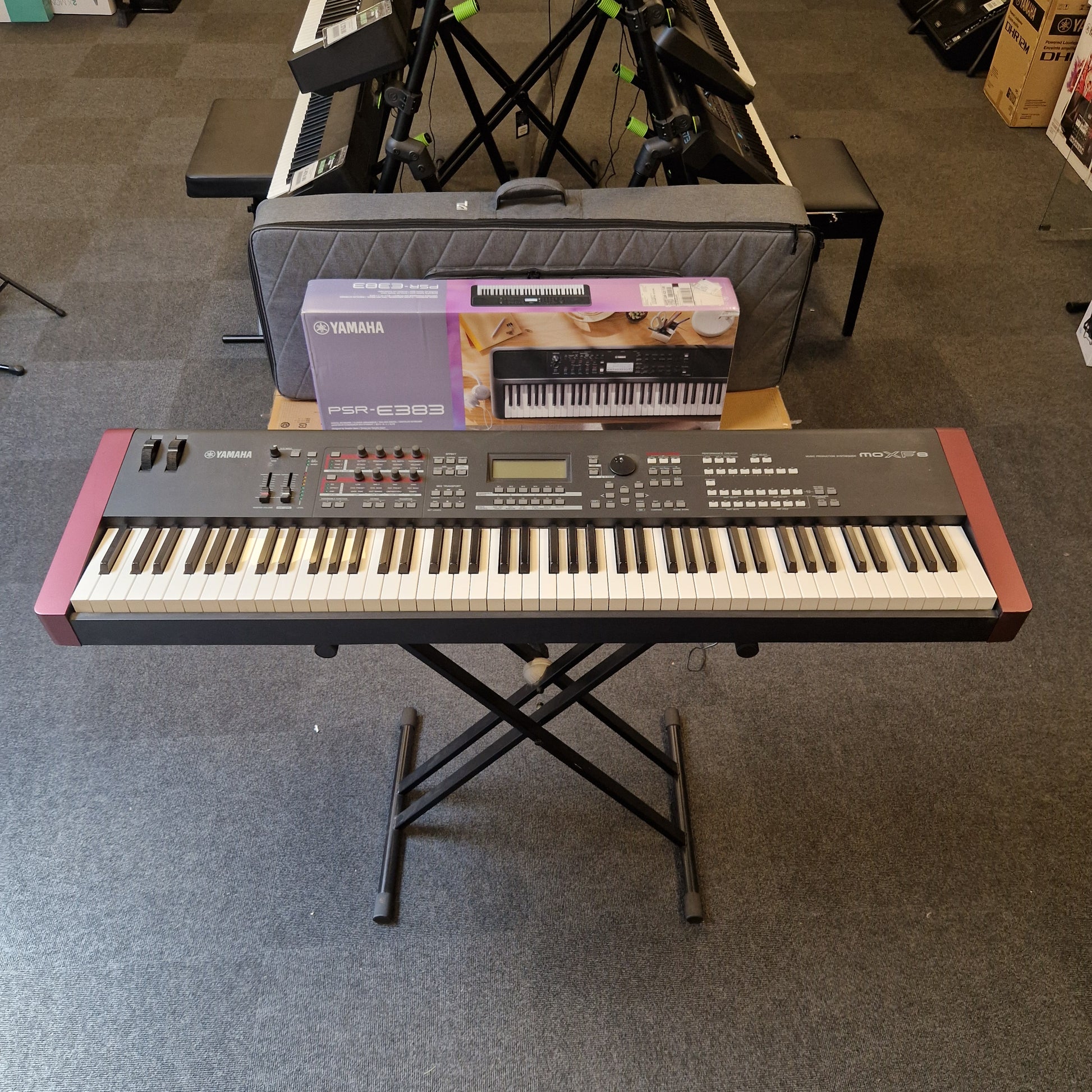 Pre-Owned Yamaha MOXF8 Keyboard on a stand in a room with other musical equipment