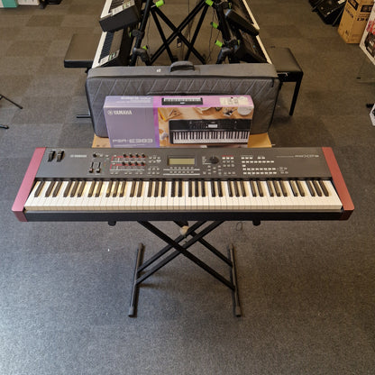 Pre-Owned Yamaha MOXF8 Keyboard on a stand in a room with other musical equipment