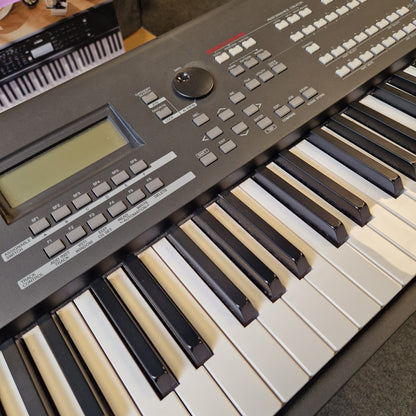 Pre-Owned Yamaha MOXF8 Keyboard with white and black keys on a gray surface