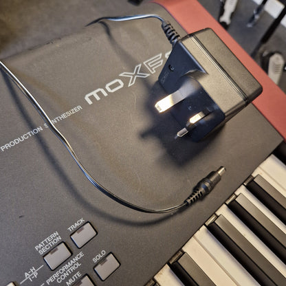 Pre-Owned Yamaha MOXF8 MOXIE power adapter and cable on a keyboard
